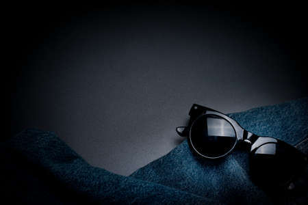 Modern background with jeans and sunglasses, with free space for text.の写真素材
