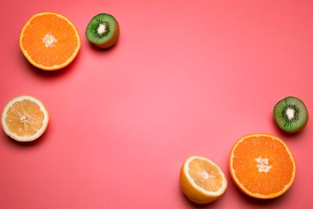 Fruits on the pink background. Orange, lemon, kiwi. Free space for text.の写真素材