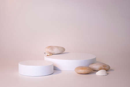 White podium on the white background. Podium for product, cosmetic presentation. Creative mock up. Pedestal or platform for beauty products.の写真素材