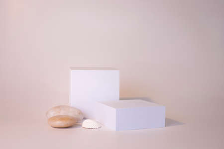 White podium on the white background. Podium for product, cosmetic presentation. Creative mock up. Pedestal or platform for beauty products.の写真素材