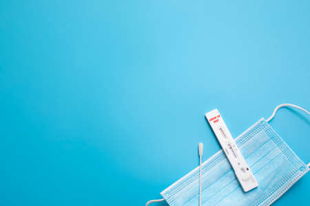 Rapid Coronavirus test on the blue background.