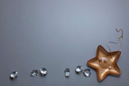 Jewellery and diamonds on the grey background. Free space, copy space. Fashion, beauty backdrop.