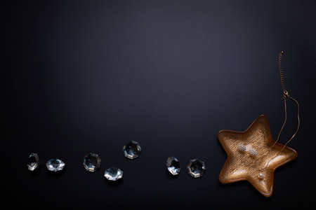 Jewellery and diamonds on the black background. Free space, copy space. Fashion, beauty backdrop.