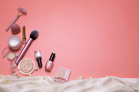 Pink beauty background with facial cosmetic, make-up products. Free space for text, copy space. Modern layout, top view, flat lay. Make up, skin care, beauty concept.の写真素材
