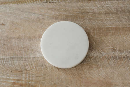 Mockup for text or logo. Free space, copy space. White, round, marble form on old, vintage wood...