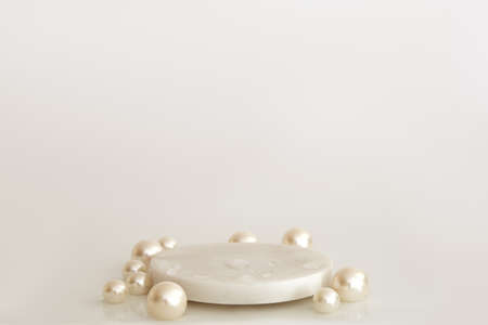 White marble podium with pearls and water drops on the white background. Podium for product, cosmetic presentation. Creative mock up. Pedestal or platform for beauty products.の写真素材