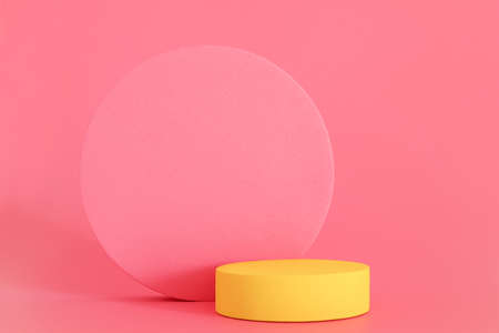 Yellow podium on the pink background. Podium for product, cosmetic presentation. Free space, copy space for text or logo. Pedestal or platform for beauty products.の写真素材