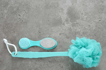 Blue bathroom accessories on concrete background. Selfcare, body care, relaxation. Top view, flat lay. Free space for text, copy space.の写真素材