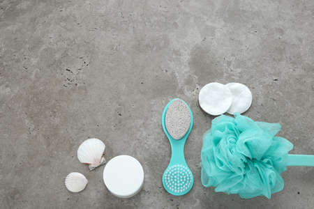 Blue bathroom accessories on concrete background. Selfcare, body care, relaxation. Top view, flat...
