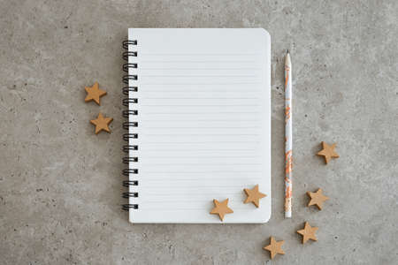 Top view of notebook with Christmas decorations. Goals, plans, dreams and to do list for new year. Free space, copy space, mockup or template for your text.の写真素材