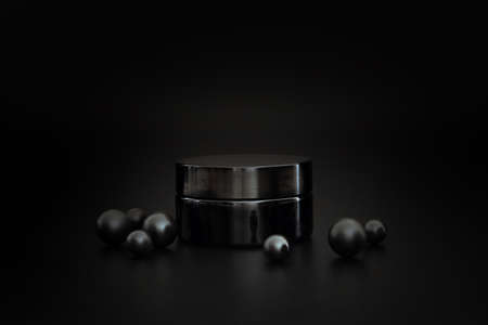 Black unbranded cosmetic cream jar. Cream presentation on the black background. Elegant mockup....