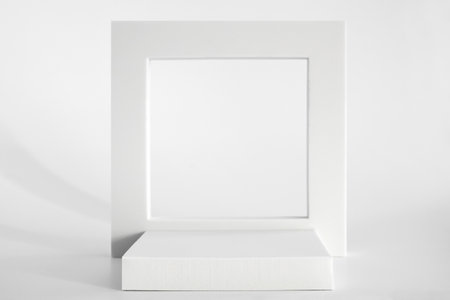 White podium on the white background, simple geometric forms. Podium for product, cosmetic presentation. Creative mock up. Pedestal or platform for beauty products.の写真素材