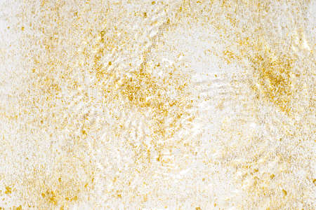 Golden sparkles in water. Gold glitter and liquide texture. Abstract background with golden particles. Shining celebration background. Festive backdrop for your projects.の写真素材