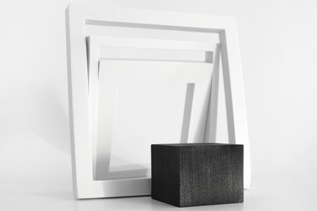 Black podium with white simple geometric forms on the white background. Podium for product, cosmetic...