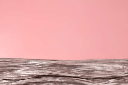Shiny silver fabric on pink background. Free space, copy space for your text and design. Events,...