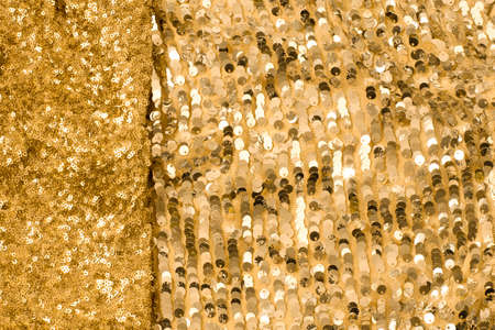 Shiny and glittering, golden fabrics with sequins. Abstract background. Events, celebrations,...