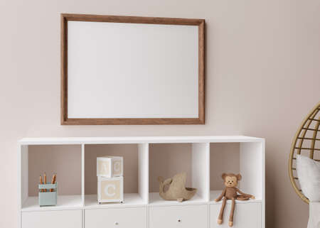 Empty picture frame on light brown wall in modern child room. Mock up interior in scandinavian, boho...