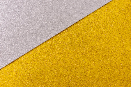 Shiny and glittering surface. Silver and gold, abstract background. Events, celebrations. Trendy backdrop for your design. Texture with glitter.の写真素材