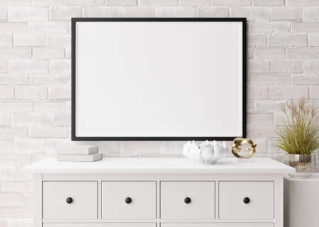 Empty horizontal picture frame on white brick wall in modern living room. Mock up interior in...