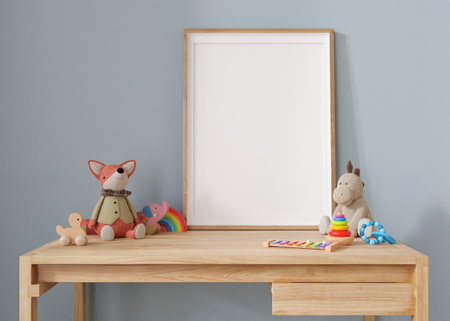 Empty vertical picture frame standing on the desk in modern child room. Frame mockup in contemporary style. Free, copy space for picture, poster. Plush and wooden toys. Close up view. 3D renderingの写真素材