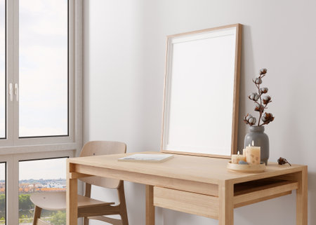 Empty vertical picture frame standing on wooden desk in modern room. Mock up interior in...