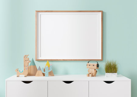 Empty horizontal picture frame hanging on blue wall in modern child room. Frame mock up in contemporary style. Free, copy space for picture, poster. Wooden toys. Close up view. 3D rendering.の写真素材