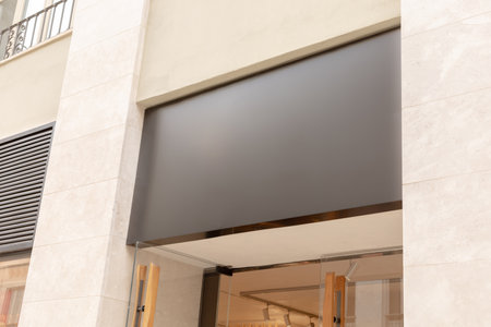 Sleek, modern storefront awning provides a perfect blank canvas for a business's text or logo, ideal for brand marketing visuals. Black signboard mockupの写真素材