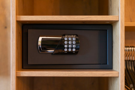 A sleek safe is mounted within a wooden shelf, featuring a digital keypad. This setup highlights the importance of secure storage in a modern spaceの写真素材