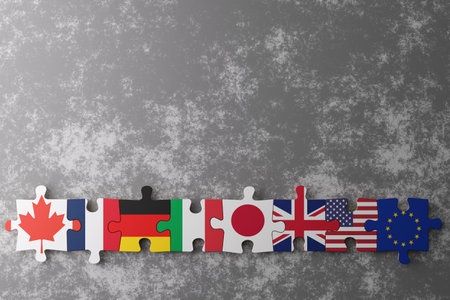 Puzzle pieces display flags of Canada, Germany, Italy, Japan, the United Kingdom, United States, and the European Union against a textured grey backdrop, symbolizing unity among nations. Copy space.の写真素材