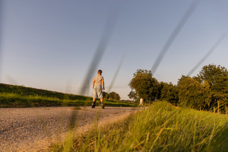 Friends can be seen inline skating along a peaceful path surrounded by greenery. The sun sets,...