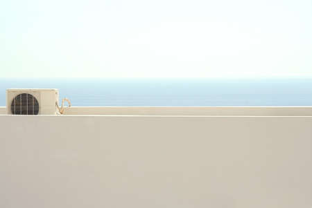 Air handling unit at a flat roof, in the back the ozeanの写真素材