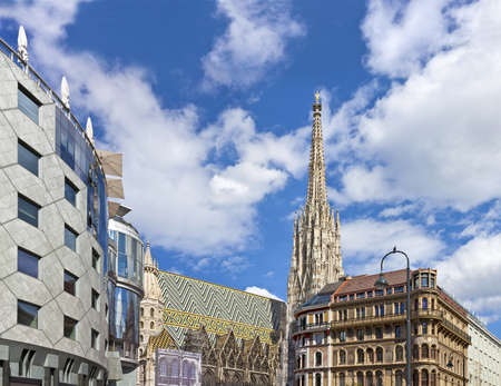 The Vienna Stephansdom with the so called Haas-Haus opposite on a sunny day at the all time well-frequented Stephansplatz  The Stephansplatz is a square at the geographical centre of Vienna のeditorial素材