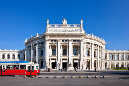VIENNA, AUSTRIA - OCTOBER 8, 2010: Historic Burgtheater (Court Theatre) at the famous Wiener Ringstrasse with some people and the tramway number one in front. Its one of the most important German language theatres in the world.のeditorial素材