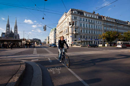VIENNA, AUSTRIA - OCTOBER 8, 2010: Urban Scene at a crossing in the city of Vienna with traffic of cars, bicycle and peopleのeditorial素材