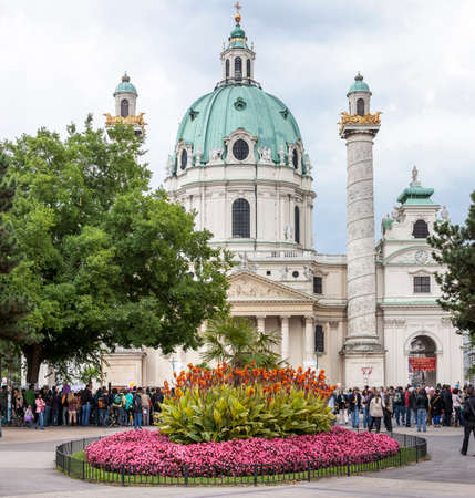 VIENNA, AUSTRIA - SEPTEMBER 15, 2012: Many people standing in front of the famous Saint Charles's Church (Wiener Karlskirche) at Karlsplatz. It's the most outstanding baroque church in Vienna, as well as one of the city's greatest buildings.のeditorial素材