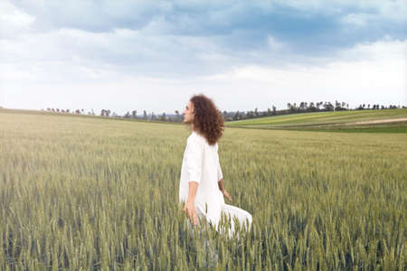 Young adult dressed in white and smiling.の写真素材