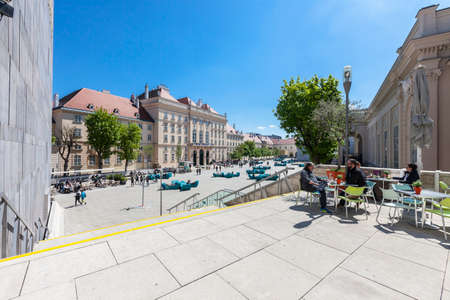 VIENNA, AUSTRIA - APRIL 29, 2016: Many people enjoy a sunny afternoon at the Museumsquartier in Vienna. It is the eighth largest cultural area in the world.のeditorial素材