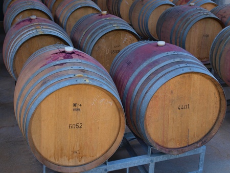 Wine barrels in arrangement waiting in a cellar