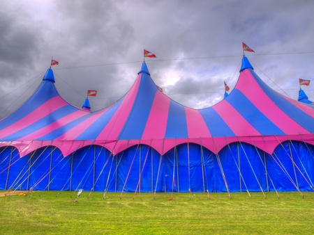 Big top circus tent on a field with brooding skyの写真素材