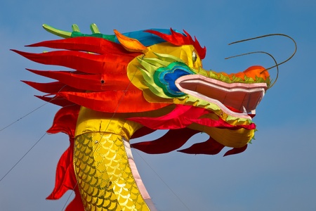 Multicolored Chinese dragon against blue skyの写真素材