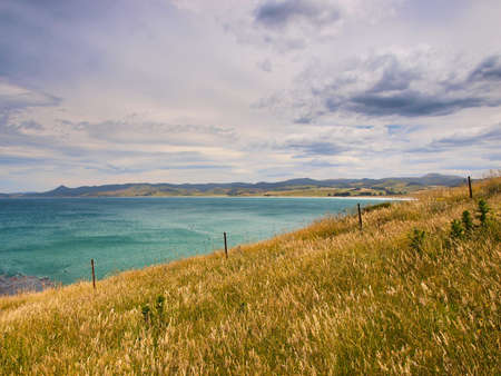 Abstract background of grassland fence with coastal backdrop