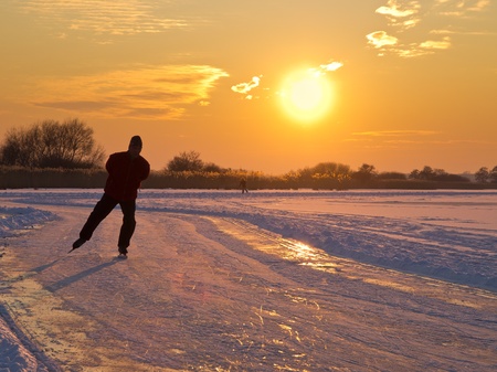 An ice skater is aproaching during sunsetの写真素材