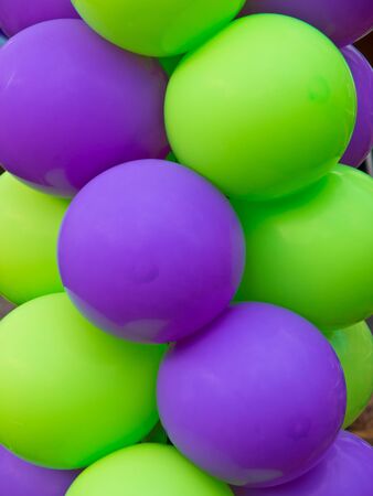 Green and Purple balloon background at a partyの写真素材