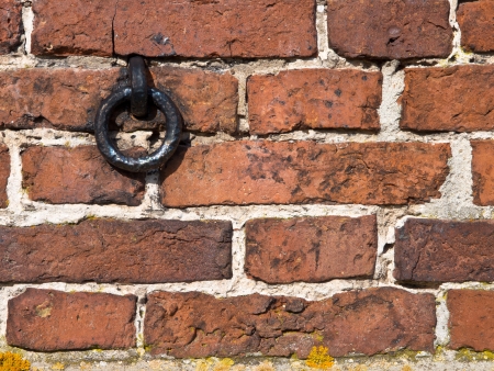 Old european brick wall with metal ringの写真素材