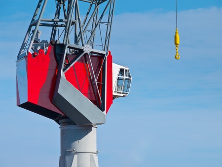 Detail of a Red Modern Harbor Crane against a Blue Skyの写真素材