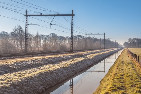 Dutch Railroad on a Rimed Winter Morning in the Rising Sunの写真素材