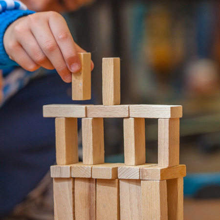 Boy Building a Structure from Wooden Building Blocksの写真素材