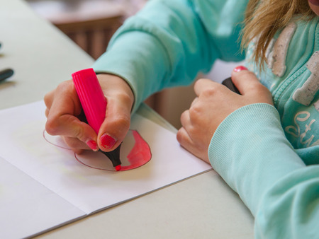 Student Writing in Notebook during Lesson on Schoolの写真素材