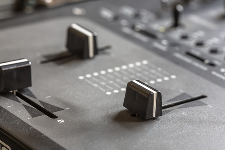 Close up of a Dj mixing panel at a home studio setting