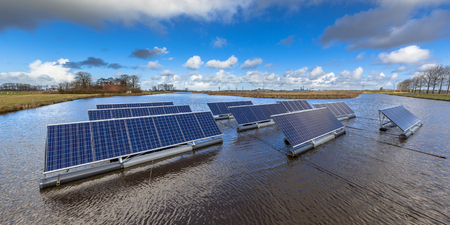 Groups of Floating solar panels on unused water bodies can represent a serious alternative to ground mounted solar systemsの写真素材